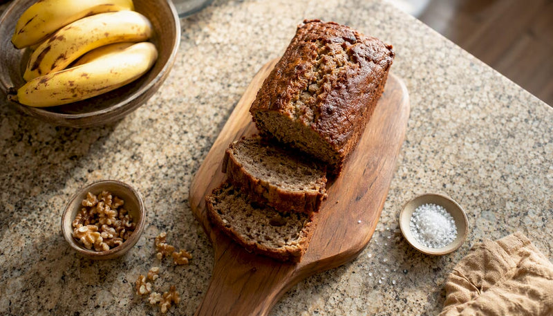 Sliced homemade protein banana bread on wood board