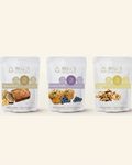Three stand-up pouches of Bell's Healthy Bites protein snacks are shown on a white background: Banana Bread, Blueberry Muffins, and Chocolate Chip Cookie.